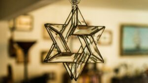 Closeup of Star of David made of glass hanging in a room